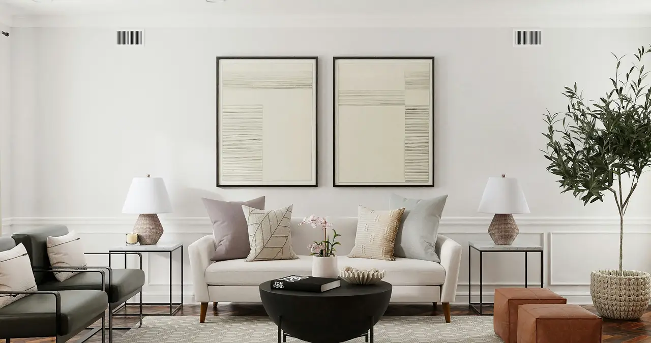 A calm living room with two framed line artworks above a cream sofa